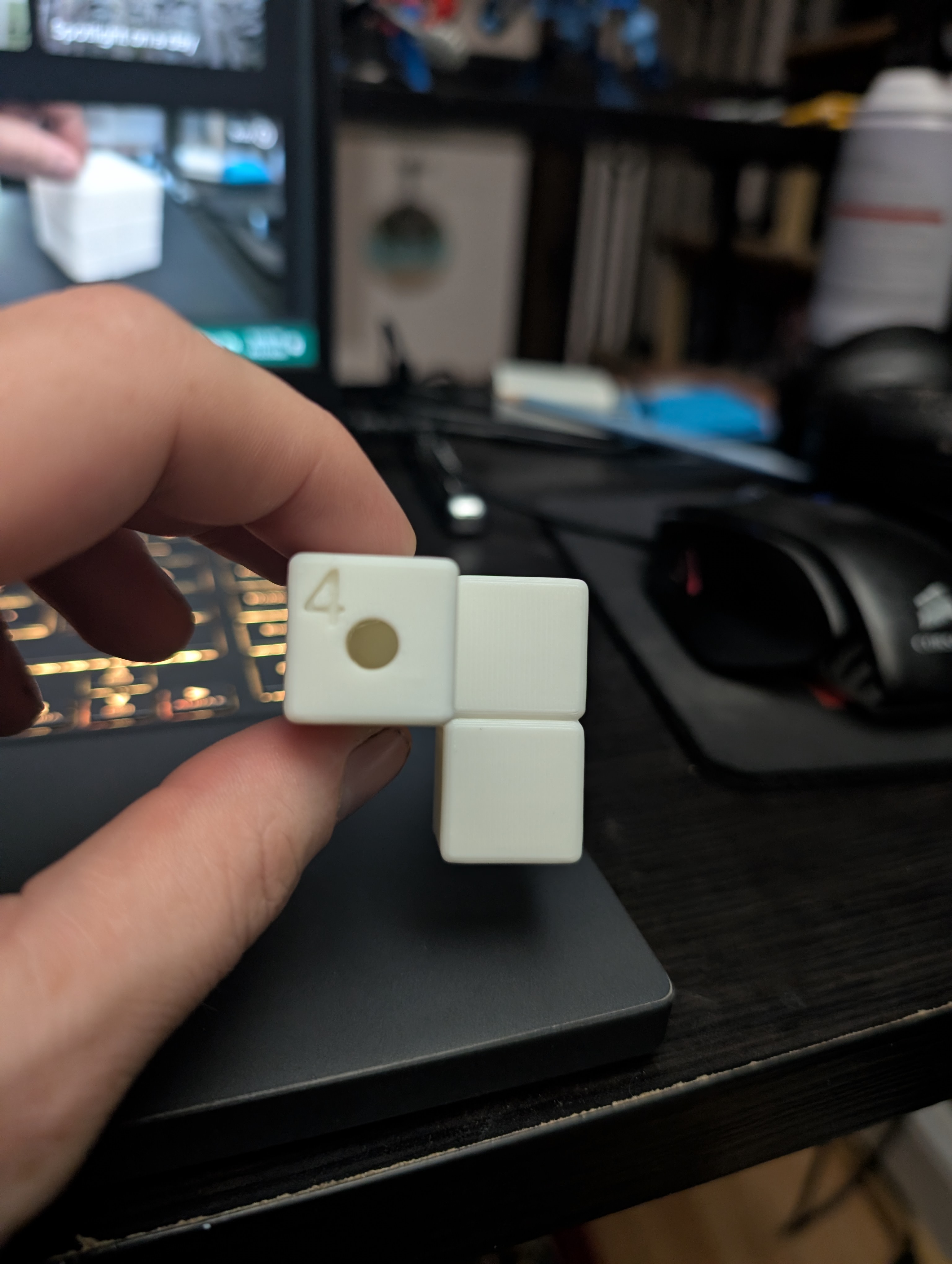 The number 4 embossed into a soma cube piece